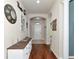 Bright entryway with hardwood floors, a white dresser, and wall decor at 5919 Lexington Dr, Parrish, FL 34219