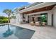 Outdoor kitchen and patio area with pool views at 1783 Bayview Dr, Sarasota, FL 34239