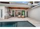 Outdoor kitchen, patio seating, and pool views at 1783 Bayview Dr, Sarasota, FL 34239