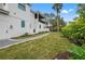 Landscaped side yard with a pathway leading to the back of the house at 1783 Bayview Dr, Sarasota, FL 34239