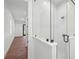 Modern bathroom with a walk-in shower and access to bedroom at 1783 Bayview Dr, Sarasota, FL 34239