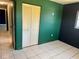 Bedroom with green and dark walls, tile floors, and a closet at 3553 Syracuse St, Port Charlotte, FL 33952