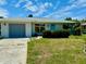 Updated ranch house with a gray garage door and nicely manicured landscaping at 3553 Syracuse St, Port Charlotte, FL 33952