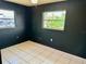 Bedroom with dark walls, tile floors, and a window at 3553 Syracuse St, Port Charlotte, FL 33952