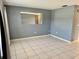 Spacious living room with gray walls and tile floors at 3553 Syracuse St, Port Charlotte, FL 33952