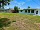 Large backyard with grassy area and partial view of neighboring house at 3553 Syracuse St, Port Charlotte, FL 33952