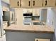 Kitchen with light cabinets and stainless steel refrigerator at 3553 Syracuse St, Port Charlotte, FL 33952