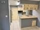 Kitchen features light cabinets, tile counters, and appliances at 3553 Syracuse St, Port Charlotte, FL 33952