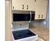 Updated kitchen with a microwave and electric cooktop at 3553 Syracuse St, Port Charlotte, FL 33952