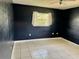 Spacious bedroom with dark walls and tiled floors at 3553 Syracuse St, Port Charlotte, FL 33952