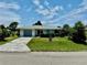 One-story house with gray garage door, and a well-maintained lawn at 3553 Syracuse St, Port Charlotte, FL 33952