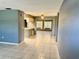 Open living room with tile floors and a view into the kitchen area at 3553 Syracuse St, Port Charlotte, FL 33952