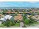 Aerial view of a luxurious home with a large backyard and paved driveway, offering stunning water views at 4713 Mainsail Dr, Bradenton, FL 34208