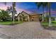 A beautiful home with a brick driveway, welcoming porch, and lush landscaping at 4713 Mainsail Dr, Bradenton, FL 34208