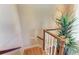 Wooden staircase with a modern design and plant decor at 4713 Mainsail Dr, Bradenton, FL 34208