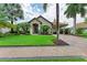 Single-Gathering home with a welcoming front yard, lush landscaping, and a paved driveway at 4713 Mainsail Dr, Bradenton, FL 34208