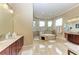 Large bathroom with soaking tub, shower, and and vanities at 4713 Mainsail Dr, Bradenton, FL 34208