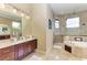Elegant bathroom with double sinks, large shower and soaking tub at 4713 Mainsail Dr, Bradenton, FL 34208