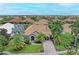 An aerial view of a single-Gathering home with a terracotta roof, nestled in a waterfront community at 4713 Mainsail Dr, Bradenton, FL 34208