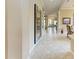 Long hallway with tile floors and view into the kitchen area at 4713 Mainsail Dr, Bradenton, FL 34208