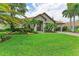 Single-Gathering home with a welcoming front yard, lush landscaping, and a paved driveway at 4713 Mainsail Dr, Bradenton, FL 34208