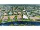 Aerial view showcasing a beautiful home in a desirable neighborhood with lush landscaping and water access at 4713 Mainsail Dr, Bradenton, FL 34208