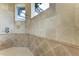Walk-in shower with tile surround and window for natural light at 4713 Mainsail Dr, Bradenton, FL 34208