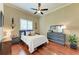 Cozy bedroom with a queen bed and wood floors at 4713 Mainsail Dr, Bradenton, FL 34208