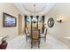 Formal dining room with a glass-top table and elegant chairs at 4713 Mainsail Dr, Bradenton, FL 34208