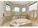 Bathroom with large walk-in shower and corner soaking tub at 4713 Mainsail Dr, Bradenton, FL 34208