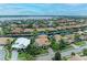 An aerial photograph showcasing a home with a tile roof in a tranquil waterfront community at 4713 Mainsail Dr, Bradenton, FL 34208