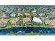 Aerial perspective of a waterfront property, highlighting the house's design and canal views at 4713 Mainsail Dr, Bradenton, FL 34208