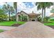 Attractive paver driveway and landscaping leading to home entrance at 4713 Mainsail Dr, Bradenton, FL 34208