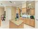 Bright kitchen with double ovens, gas cooktop, and granite island at 4713 Mainsail Dr, Bradenton, FL 34208