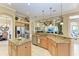 Open kitchen with large island and views into Gathering room at 4713 Mainsail Dr, Bradenton, FL 34208
