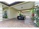 Covered parking area with paver driveway and lush landscaping at 4713 Mainsail Dr, Bradenton, FL 34208
