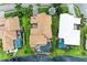 High-angle view of a luxury home with a private pool and lush landscaping near the water at 4713 Mainsail Dr, Bradenton, FL 34208