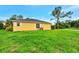 Side view of the house showing a large grassy yard at 3530 Adelaide Ave, North Port, FL 34288