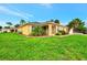 Yellow house with screened porch and lush lawn at 3530 Adelaide Ave, North Port, FL 34288