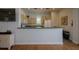 Community kitchen with white cabinets and appliances at 1260 Dolphin Bay Way # 203, Sarasota, FL 34242