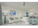 Bright and airy living room with comfy seating and a view to the dining area at 1260 Dolphin Bay Way # 203, Sarasota, FL 34242