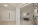 Bright entryway with view to living room and neutral tile floors at 1260 Dolphin Bay Way # 203, Sarasota, FL 34242
