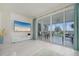 Living room with large TV, access to lanai, and light flooring at 1260 Dolphin Bay Way # 203, Sarasota, FL 34242