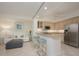Open kitchen with granite counters, stainless steel appliances, and breakfast bar at 1260 Dolphin Bay Way # 203, Sarasota, FL 34242