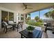 Spacious screened lanai with water views, seating area, and dining table at 1260 Dolphin Bay Way # 203, Sarasota, FL 34242