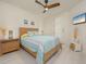 Guest bedroom with light wood furniture and colorful bedding at 1260 Dolphin Bay Way # 203, Sarasota, FL 34242