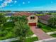 Two-story house with red roof and brick driveway at 2352 Marton Oak Blvd, North Port, FL 34289