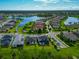 Aerial view of a lakeside community with well-maintained homes and lush landscaping, close to water at 2352 Marton Oak Blvd, North Port, FL 34289