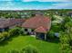 This fantastic aerial shows the home with its tile roof, backyard, and landscaping with a view of the community at 2352 Marton Oak Blvd, North Port, FL 34289