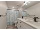 Bathroom with double sink vanity, modern faucets and fixtures, and walk-in shower at 2352 Marton Oak Blvd, North Port, FL 34289